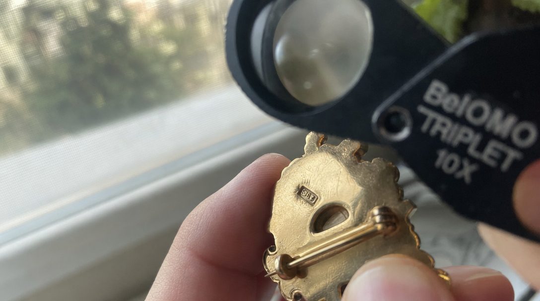 A loupe held over a hallmark