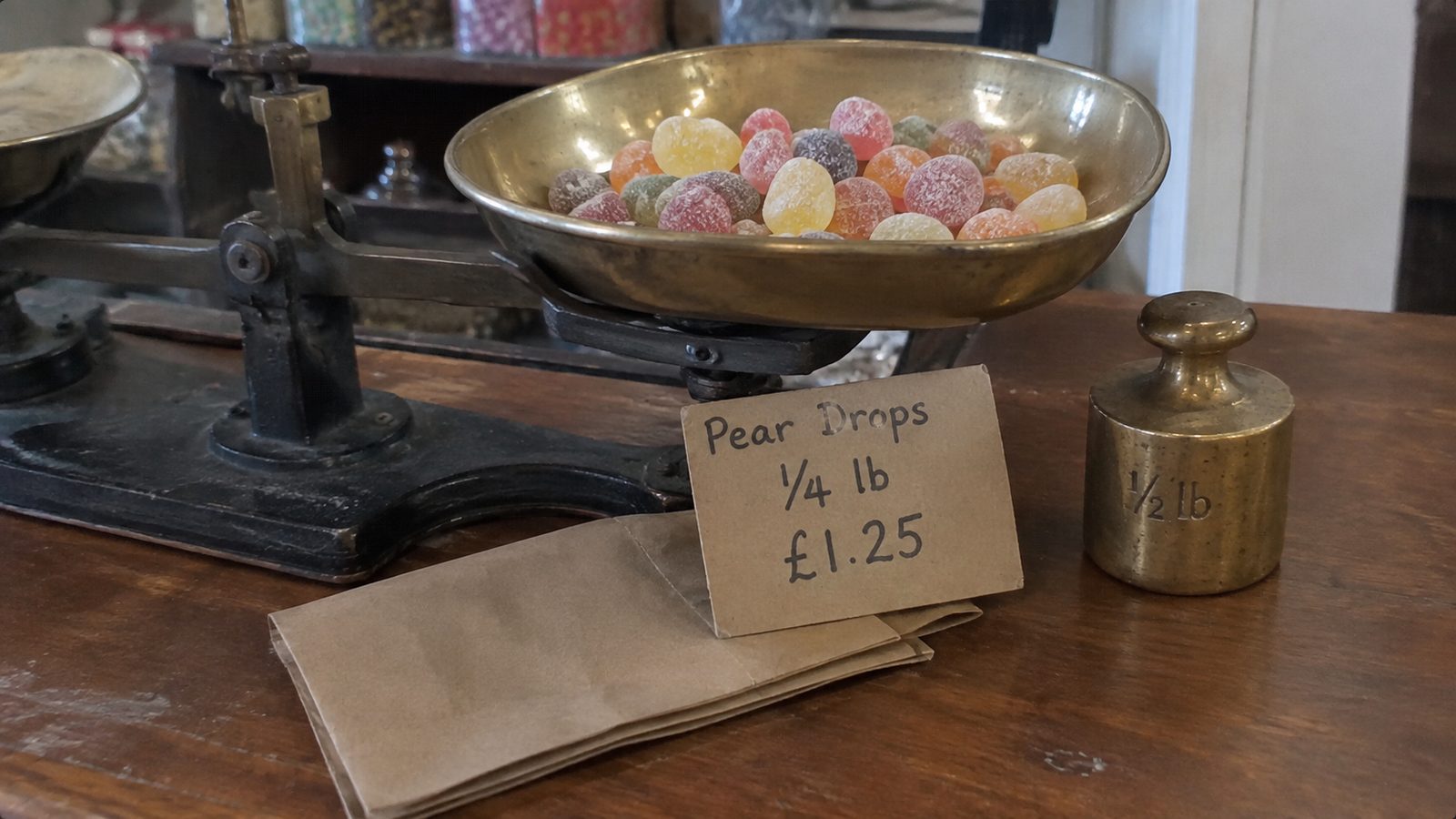 Brass shop scales beside a hand-written price card
