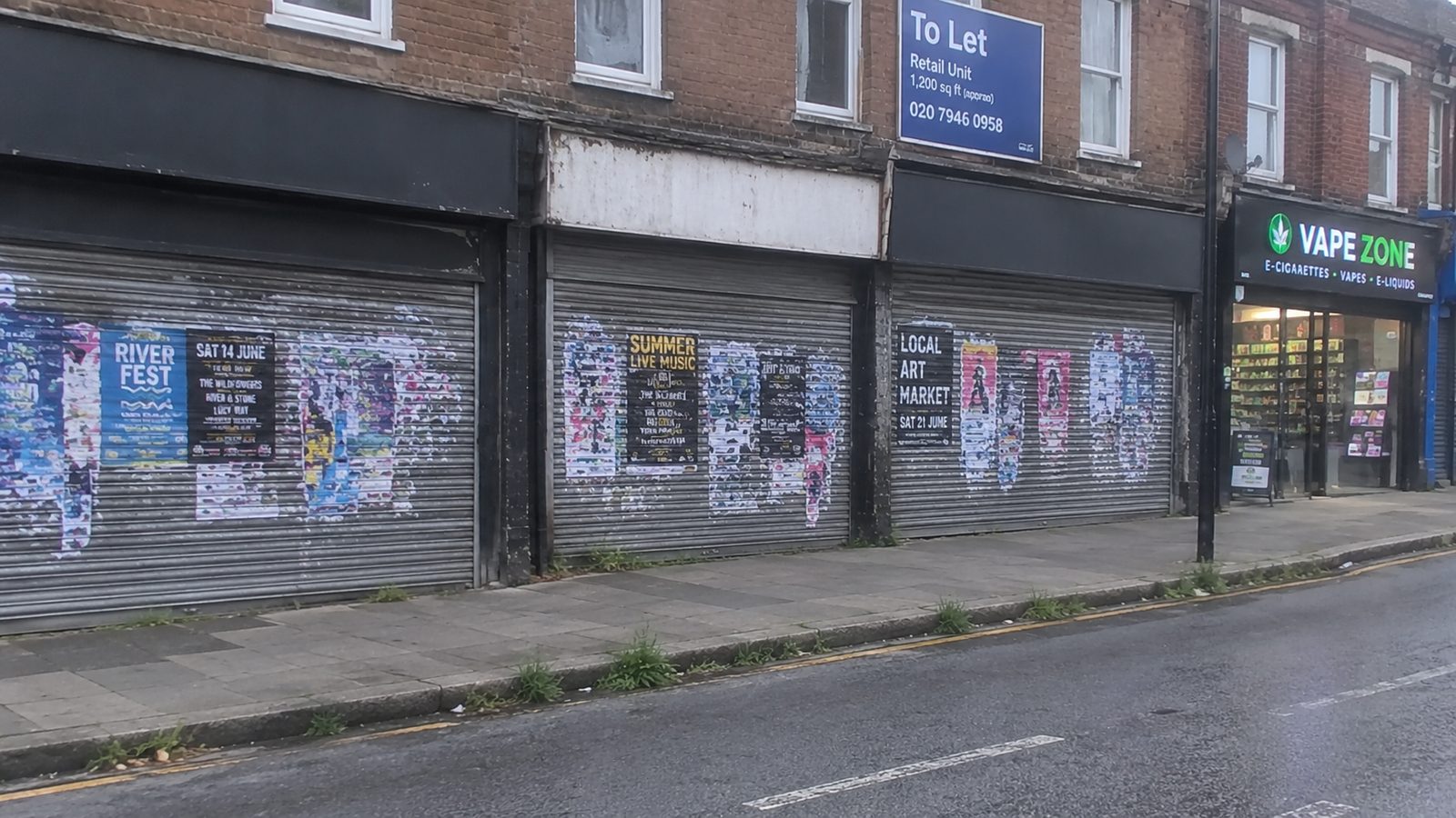 A boarded-up parade of shops on a British high street